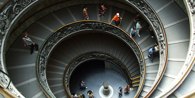 People walking down decorative staircase
