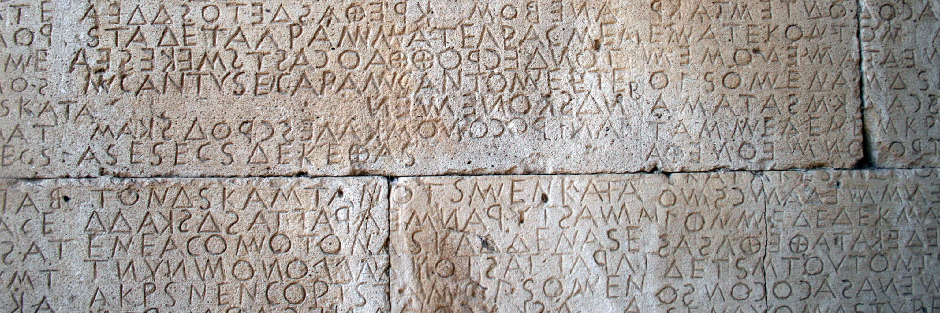 language inscriptions on a stone wall