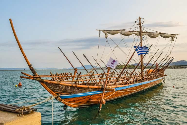ancient wooden boat floating in water