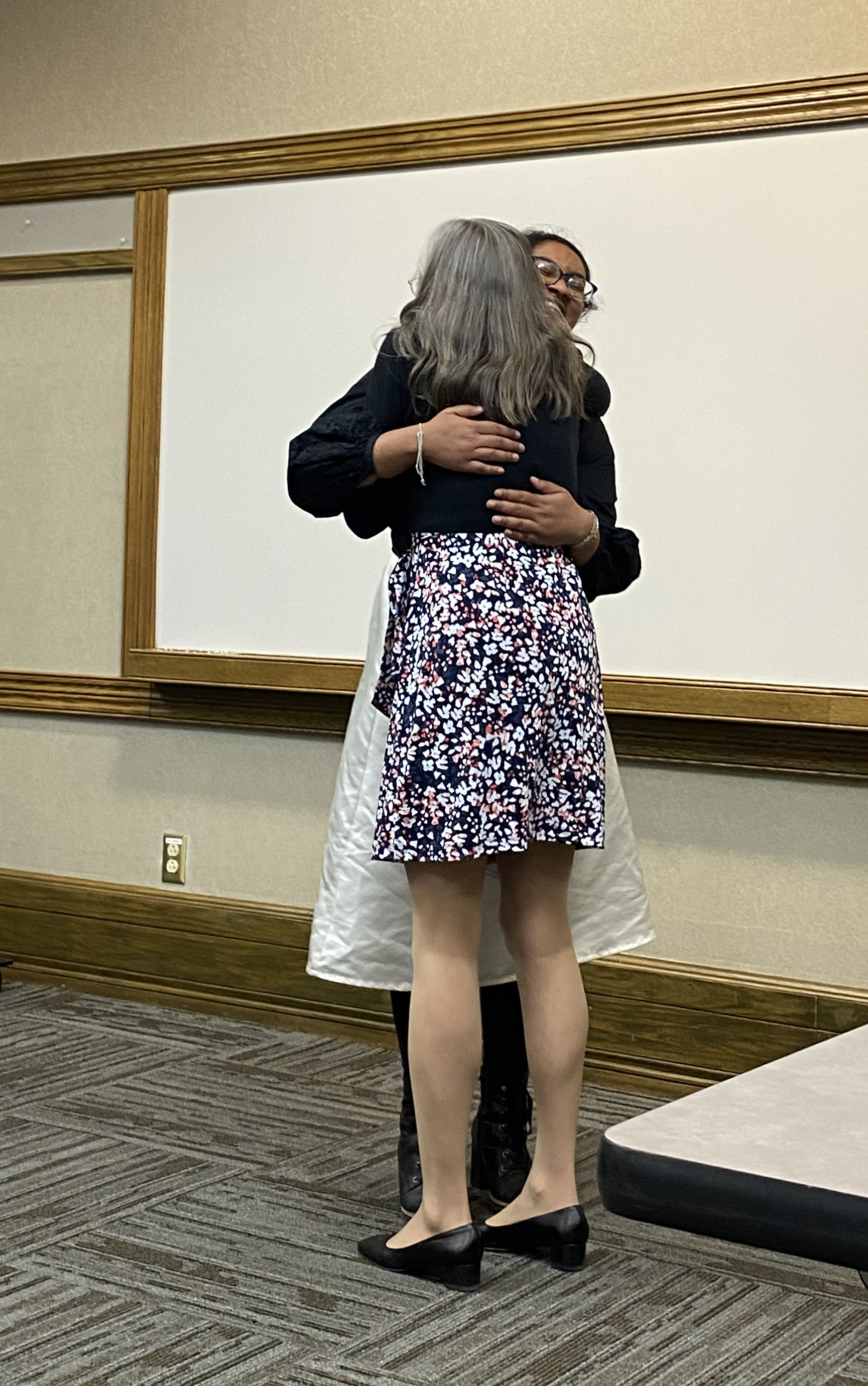 Professor and graduating senior hugging